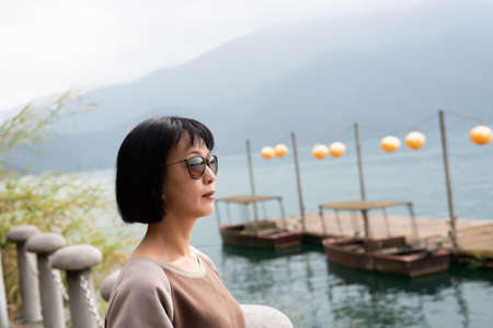 traveling mature Asian woman at Sun Moon Lake, Taiwanの写真素材