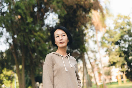 portrait of mature Asian beautiful woman at parkの写真素材