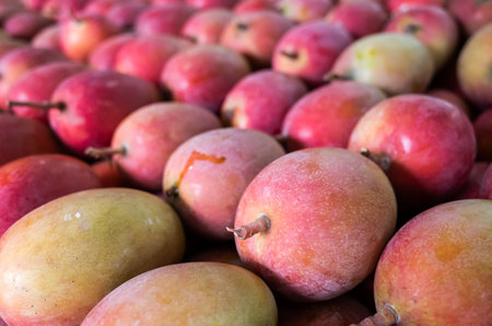 stacks of mango fruits in vivid red color at traditional marketplace, Taiwan