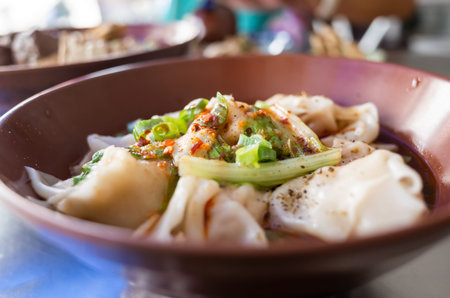 Taiwanese snacks of meat dumpling in chili oil at restaurant