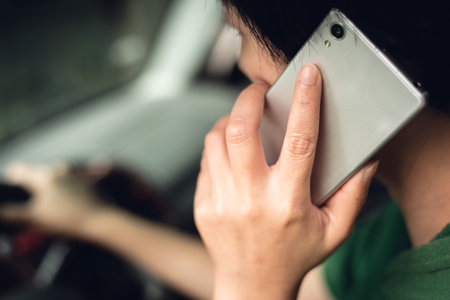 woman talking on cellphone when driving, concept of dangerous driverの写真素材