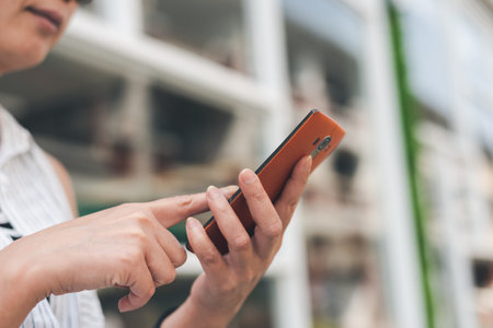 woman sitting and using cellphone in the outdoor