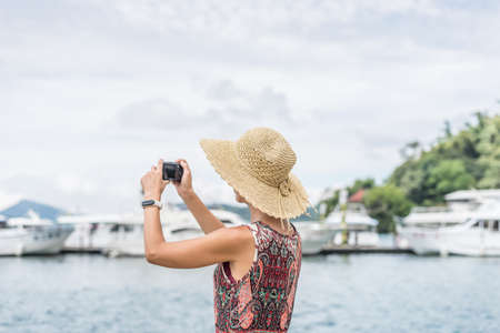 traveling Asian woman with hat take a pictures at Sun Moon Lake, Taiwanの写真素材