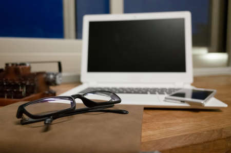 working at home with laptop on the wooden table in the nightの写真素材