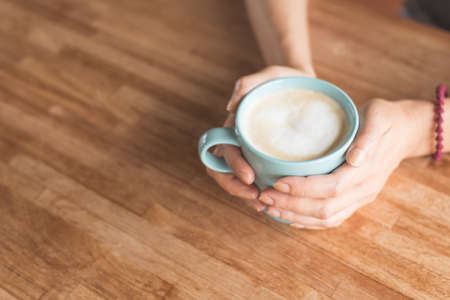 woman hold a cup a coffee at homeの写真素材