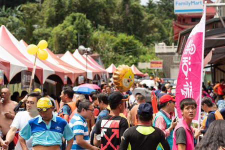 Nantou, Taiwan - September first, 2019: people walk at the marketplace street at Sun Moon Lake Swimming Carnival, Nantou, Taiwanのeditorial素材