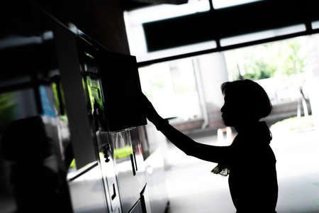 asian woman open a locker at the stationの写真素材