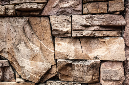 stone stacked wall in brown aged color backgroundの写真素材