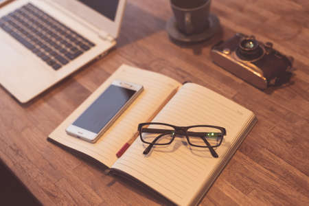 glasses and laptop on the table with nobody, concept of working at homeの写真素材