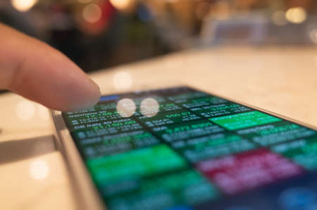 using a mobile device to check market data with bokeh copyspaceの写真素材