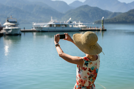 traveling woman take a picture near Sun Moon Lake, Nantou, Taiwan