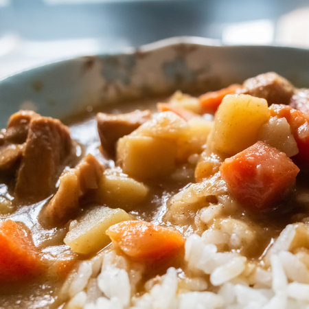 curry sauce with beef and rice on table