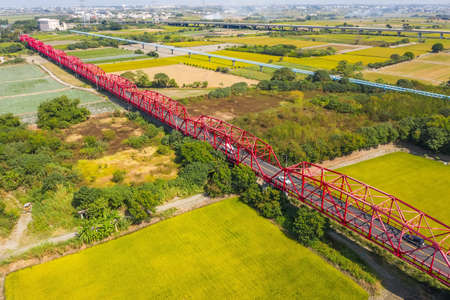 red famous Xilou Bridge over the river and farm in Yunlin county, Taiwanの写真素材