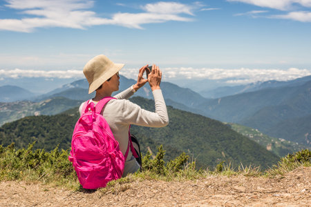 Asian climbing woman take pictures at Hehuan mountain, Taiwan