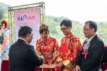 Yuchi, Taiwan - October 4th, 2019: several couples participate in a group wedding at the scenic spot of Sun Moon Lake, Nantou, Taiwanのeditorial素材