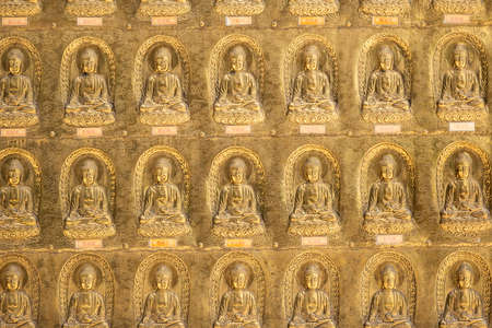 Puli, Taiwan - May 3th, 2020: golden buddhist sculpture on the wall at Chengte Foshan, Puli township, Nantou, Taiwanのeditorial素材