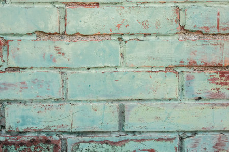 dirty red brick wall background with green painting