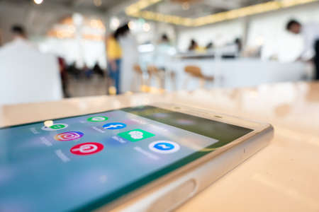 Nantou, Taiwan - March 27th, 2020: using social media at a smartphone in a restaurant, Nantou, Taiwan, Asianのeditorial素材