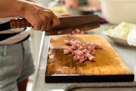 cut raw pork on wooden table in the kitchenの写真素材