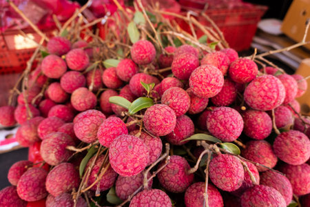red ripe lychees stacks at traditional marketplace in Taiwan