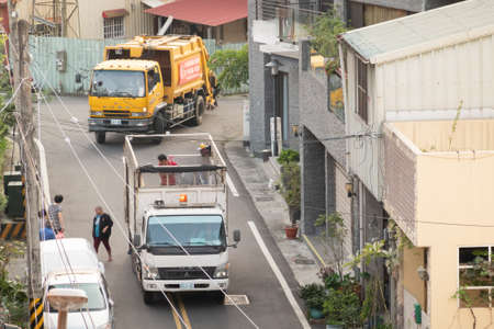 Nantou, Taiwan-November 6th, 2019: white recycling truck for collects recyclable materials in a small lanes at Puli township, Nantou, Taiwan, Asiaのeditorial素材