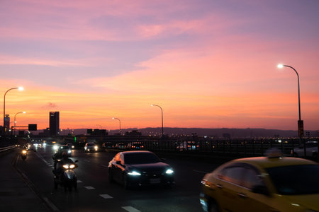 Taipei, Taiwan-Oct 2nd, 2020: sunset cityscape with silhouette of cars and buildings under dramatic sky in Taipei Taiwanのeditorial素材