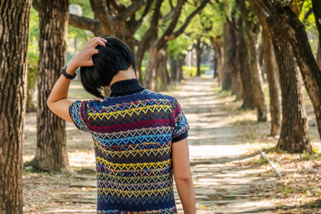 rear view of modern Asian woman in the park