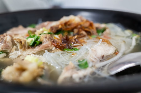 Taiwanese food of mung bean noodles with soup and pork in a bowl on the table