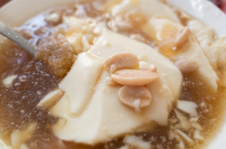 eating famous Taiwan snacks of iced tofu pudding