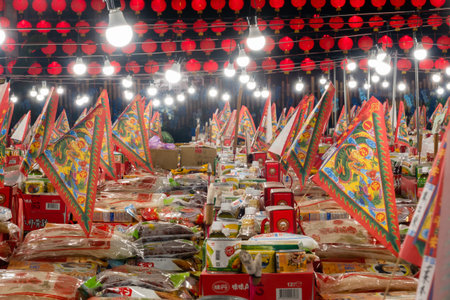 Puli Township, Taiwan - December 6th, 2020: glowing buildings and offerings on table during Taoist...