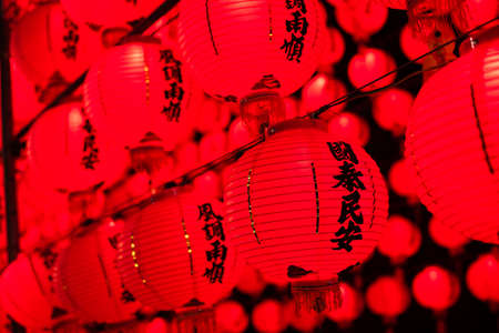 red lanterns hanging up in the night, the Chinese words on lantern means prayingの写真素材