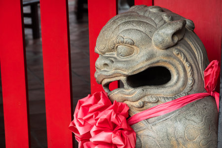 stone lion statue stand in a Chinese templeの写真素材