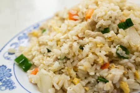 Chinese fried rice in a plate on the tableの写真素材