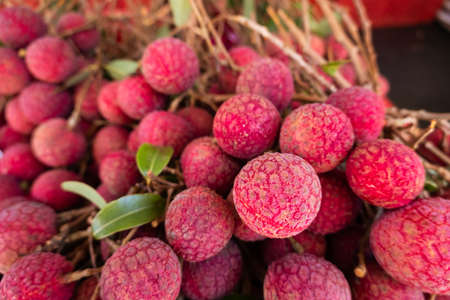 red ripe lychees stacks at traditional marketplace in Taiwanの写真素材