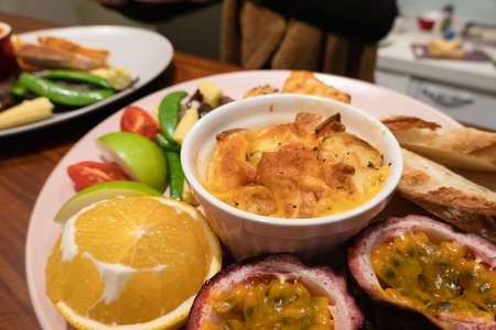 hearty breakfast with bread and fruit on a plate at homeの写真素材