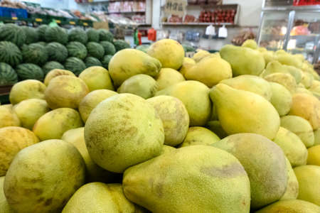 group of pomelo fruit in a traditional marketplaceの写真素材