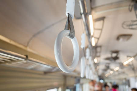 white handle on the ceiling for standing passengerの写真素材