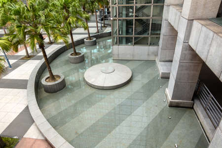 modern garden with pond and skyscrapers in the cityの写真素材