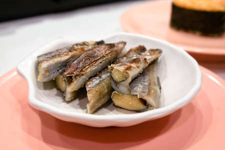 sweetfish on a dish in a fast sushi restaurantの写真素材