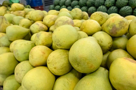 group of pomelo fruit in a traditional marketplaceの写真素材