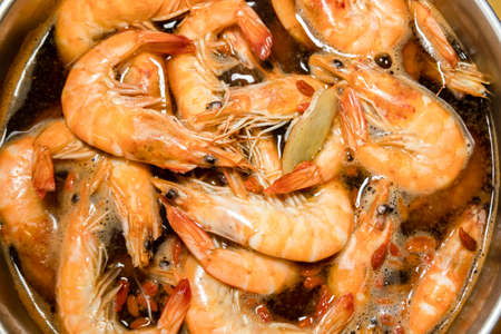 group of shrimps with soup in a potの写真素材