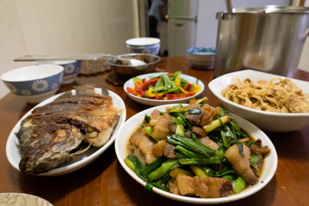 home-cooked meal with vegetable and meat on tableの写真素材