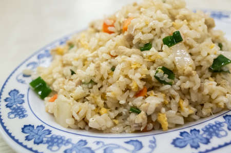 Chinese fried rice in a plate on the tableの写真素材