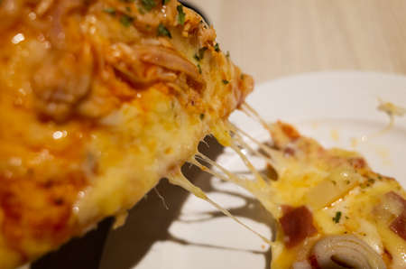 eat small piece of pizza at a restaurantの写真素材
