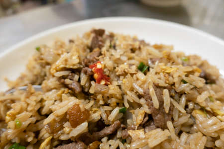 Chinese fried rice in a plate on the tableの写真素材