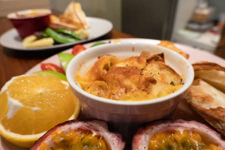 hearty breakfast with bread and fruit on a plate at homeの写真素材