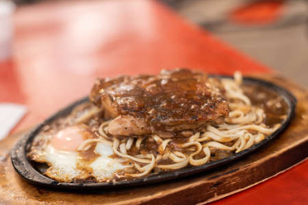 woman eat Taiwanese night market steak at the streetの写真素材