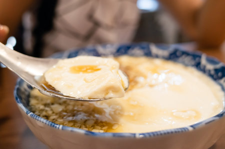 eating famous Taiwan snacks of iced tofu pudding
