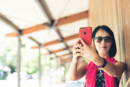 woman take a selfie at the corridor at the stationの写真素材