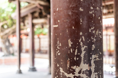 aged wooden pillar with crack paint in a temple, closeup imageの写真素材